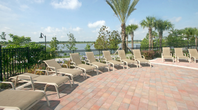 pressure washed and properly clean Florida pool deck with lounging chairs