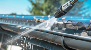 metal roofing being soft washed and cleaned by proper roof cleaning equipment and pressure